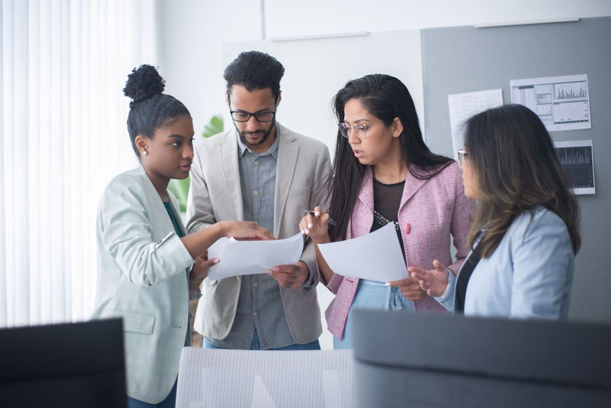 A team of professionals reviewing paperwork together